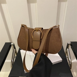 Vintage brown suede underarm bag with large bronze horseshoe buckle and leather strap