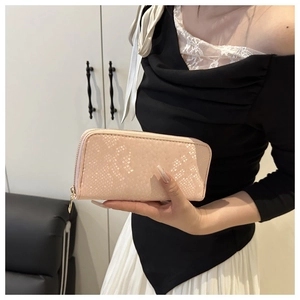 Detailed shot of nude pink long wallet with snake skin embossing and gold zipper