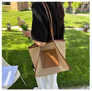 Close-up of woven tote bag with brown leather trim and fashion engraving details