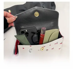 Internal view of cherry print crossbody bag showing space for phone and accessories