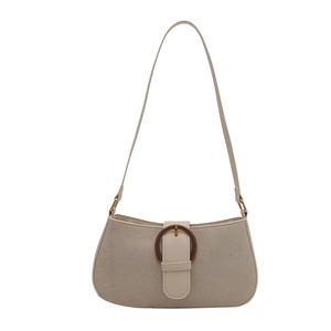 Minimalist beige baguette shoulder bag with horseshoe buckle and textured fabric finish