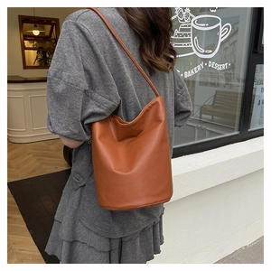 Litchi texture brown bucket bag shown from behind on model for daily commuting style