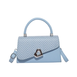 Vintage light blue leather handbag with woven chevron flap and heart-shaped metal buckle