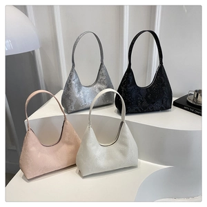 Detail of four hobo bags with fine snakeskin texture in pink, white, silver, and black