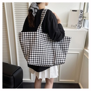 Detail of large checkered canvas tote bag with black and white gingham pattern for summer