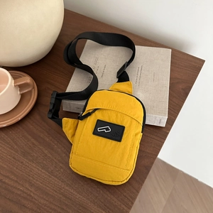 Waterproof yellow crossbody sports bag on wooden table with urban fashion style design