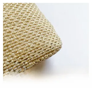 Close-up of the tight cross-weave texture on a beige straw crescent shoulder bag