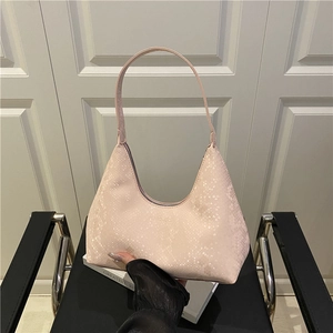 Pink snake skin textured hobo bag for women with shoulder strap in a minimalist setting