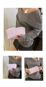 Detailed view of lavender snake pattern long wallet with metallic zipper and texture
