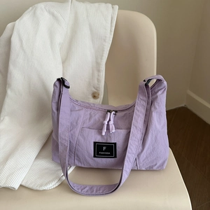 Minimalist light purple tote bag in nylon fabric on a beige chair for summer commute