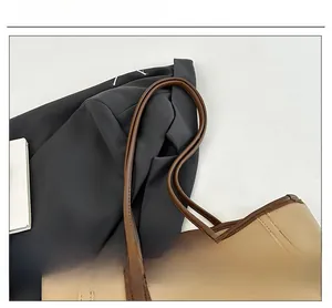 Detail of contrast-color tote bag featuring beige PU leather and slim brown shoulder straps