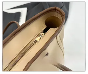 Close-up of a high-quality smooth zipper and edge oil craft on a beige tote bag