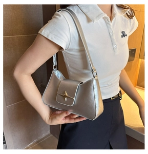 Vue détaillée du sac argenté avec boucle étoile dorée et texture métallique élégante