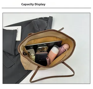 Interior view showing the large capacity of this two-tone beige and brown tote bag