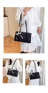 Detail shot of a quilted black shoulder bag with chic white ribbons and bow accents