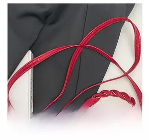 Detail of red cherry print bag showing the woven handle and comfortable shoulder strap