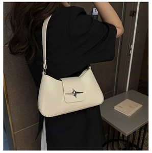 Gros plan du sac sous l'aisselle en cuir PU crème avec détail étoile argentée
