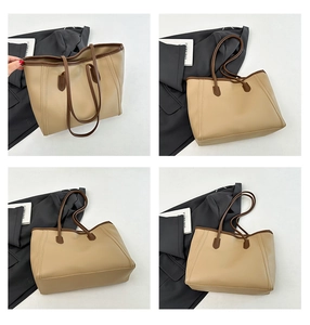 Detail view of khaki tote bag with brown handles and high-quality contrast stitching