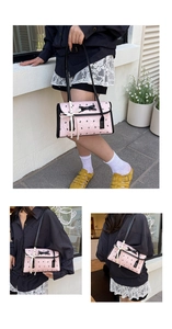 Pink fabric shoulder bag with black bunny prints and decorative bow detail show