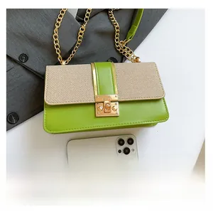 Close-up of green faux leather and woven fabric flap bag with gold chain and clasp