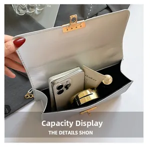 Internal view of white crossbody bag showing storage capacity for phone and cosmetics
