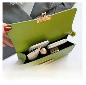 Internal view of a lime green crossbody bag showing storage for phone and cosmetics