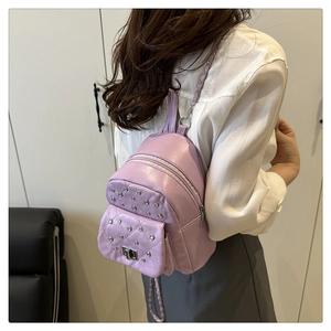 Detail of lavender quilted mini backpack with diamond stitching and metal turn-lock closure