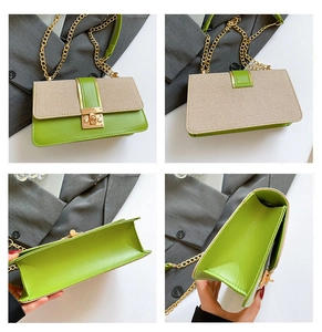 Detail view showing green leather and beige fabric patchwork with golden chain and metal lock