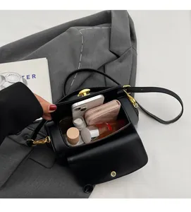 Interior view of black leather crossbody bag showing capacity for phone and wallet