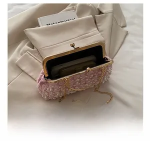 Pink pearl lace flower clutch bag showing internal space for phone and wallet