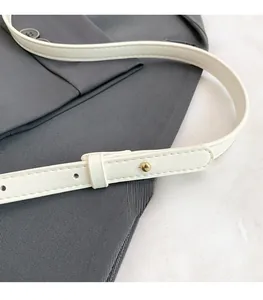 Close-up of adjustable white PU leather strap with golden buckle and clean edge stitching