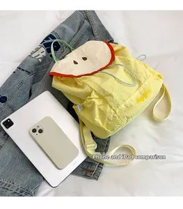 Mini yellow apple backpack detail with phone and iPad for size comparison