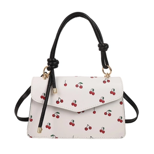 Stylish white crossbody bag with red cherry prints and black knotted handle for women