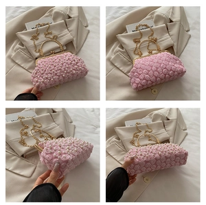Detailed view of pink lace flower evening bag with pearls and golden metal handles