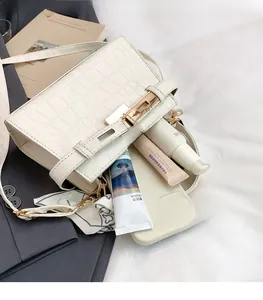 White crocodile pattern bag showing spacious interior with luxury gold hardware
