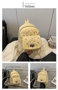 Makro-Detail des gelben Mini-Rucksack mit Strass, Rautensteppung und Metall-Drehverschluss-Detail