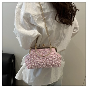 Detail of pink evening bag with 3D floral petals and white faux pearl embellishments