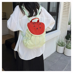 Detail showing the watermelon pattern flip cover and drawstring closure of the backpack