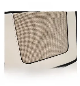 Detail of color-block tote bag featuring white leather and beige canvas stitching