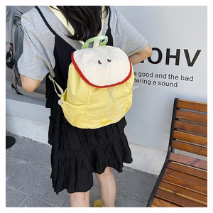 Close-up of apple-shaped casual backpack in yellow nylon fabric for daily travel