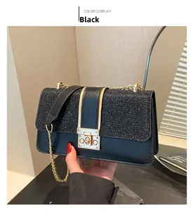Detail of black chain bag with shimmering glitter texture and golden metal buckle