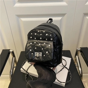Chic black mini quilted backpack with silver rhinestone studs and chain shoulder strap