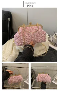 Detail of pink lace floral evening clutch with pearls, metal handle and chain strap