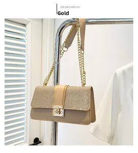 Detail of elegant gold chain bag featuring shimmering sequins and a metallic lock