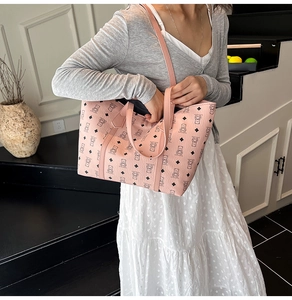 Detail of pink tote bag featuring black bear prints and textured PU leather shoulder strap