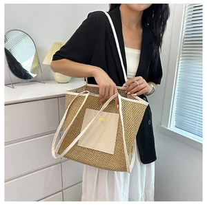 Detail of hollow woven straw tote bag featuring white trim and premium PU patch detail