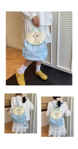 Detailed view of light blue pear-shaped backpack with drawstring and embroidery