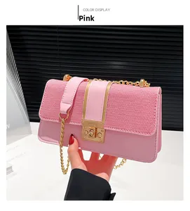 Close-up of pink woven texture bag with gold twist lock and elegant chain strap