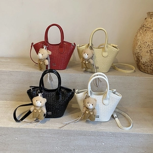 Womens Woven Bucket Bag PU Leather Casual Commuter Handbag Small Crossbody Purse With Plush Bear Pendant
