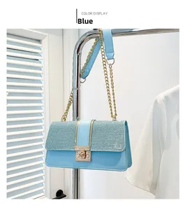 Close-up of sky blue chain shoulder bag with metallic lock and woven texture detail